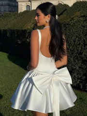 White Dress with Flared Skirt and Large Bow Detail