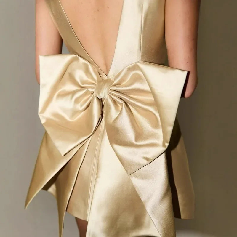 Gold Mini Dress with Statement Bow for Special Occasions